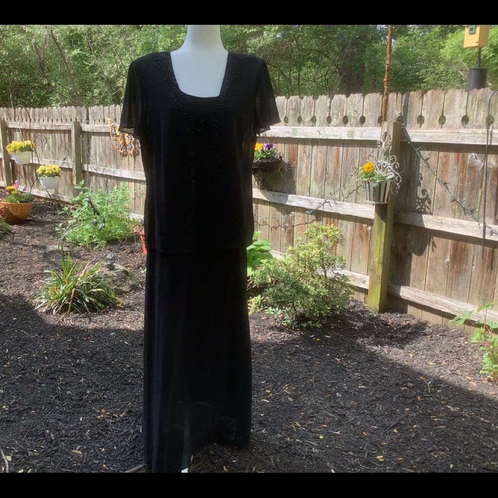 Simple yet elegant long black dress and jacket.